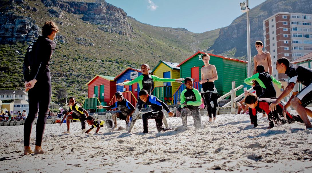 Stretching on the beach in a surfing project, South Africa Stretching on the beach in a surfing project, South Africa